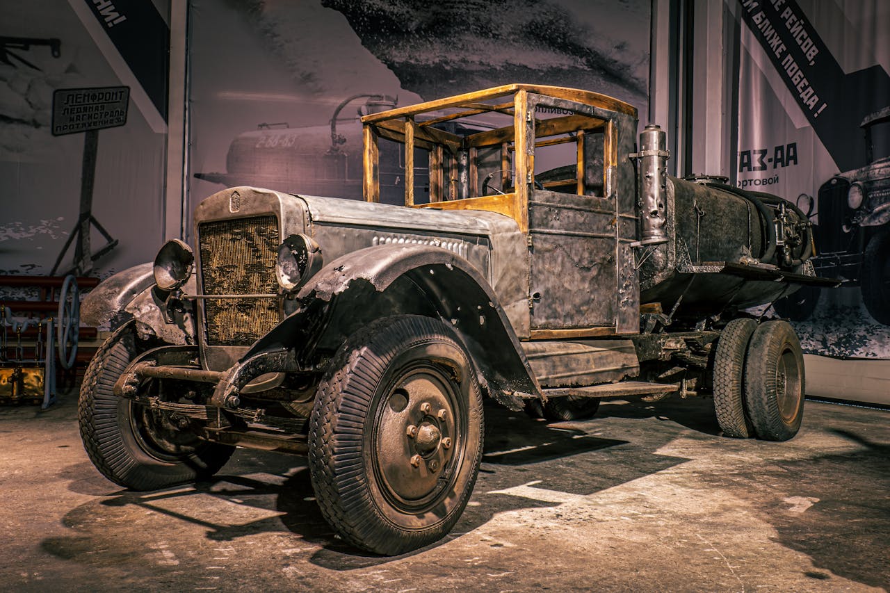 private-party-05 A classic vintage truck parked indoors in a rustic Russian garage, showcasing historic industrial design.